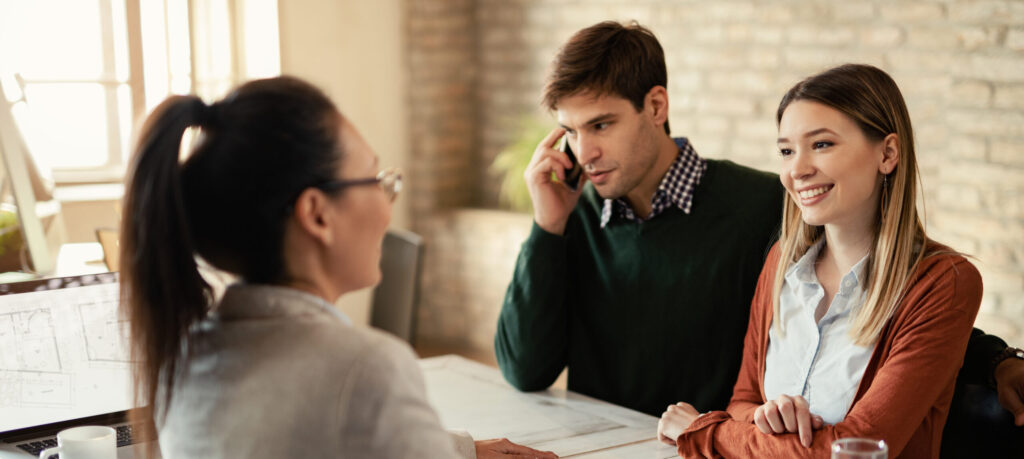 Young couple having a meeting with insurance agent in the office